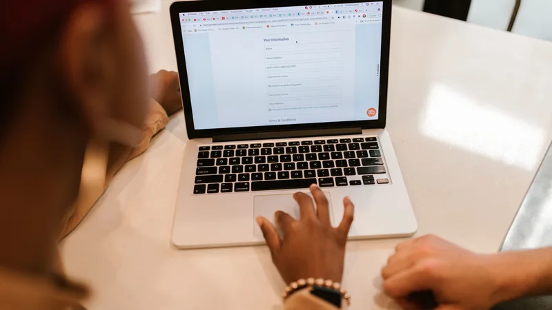 Filling out Credit Cube loan application form online on laptop