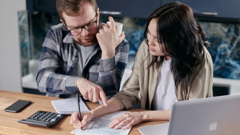 Couple reviewing Credit Cube loan repayment plan and financial documents