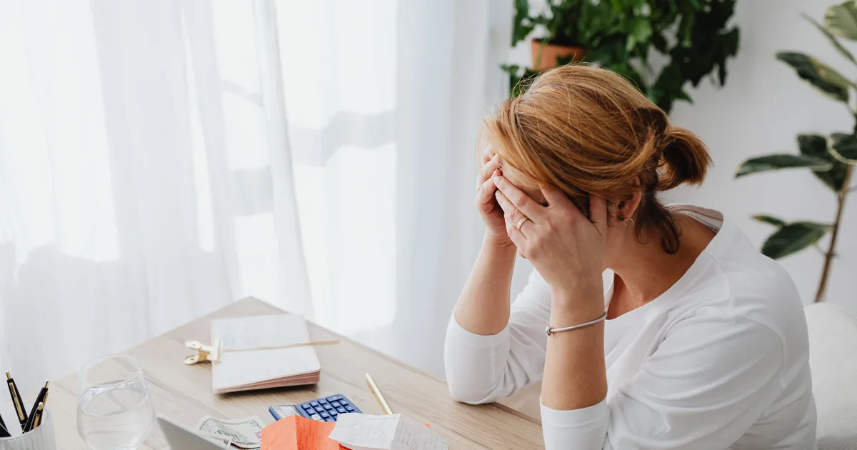 Credit Cube emergency loan — person stressed by financial bills